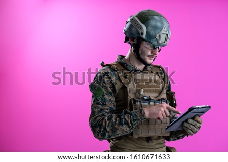 soldier using tablet computer hands closeup pnk background
