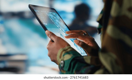 Soldier using warning system software on tablet in control room to monitor incoming enemy aerial attacks. Army agent maintains air space superiority with radar during armed conflict, close up - Powered by Shutterstock - Get 15% off with code: PIKWIZARD15