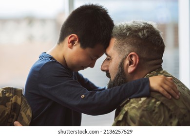 Soldier welcoming his son at home - family concepts in war - - Powered by Shutterstock