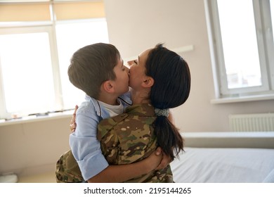 Soldier woman and boy hugging each other