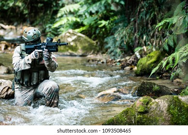 Soldiers in action in a game of airsoft with his weapon