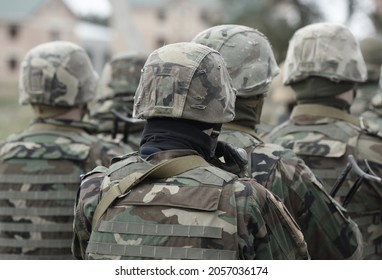 Soldiers with assault rifles from the back.