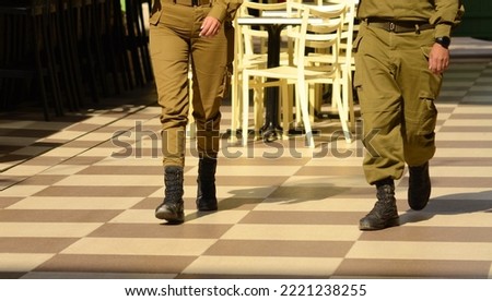 Soldier's boots on the feet of an Israeli soldier. Concept: Soldiers IDF - Israel Defense Forces (Tzahal), Israeli soldiers, Israeli army. Guy and girl soldiers, gender equality