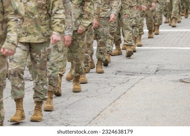 Soldiers in camouflage gear walking towards camera - Powered by Shutterstock