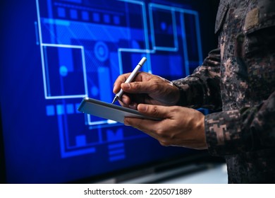 Soldiers checking to building plan management. Paving a path on electronic screen. - Powered by Shutterstock