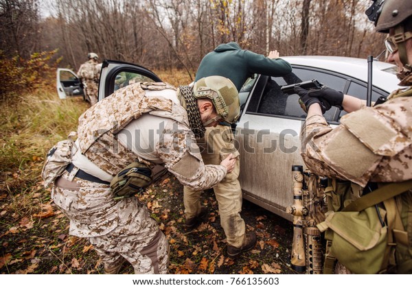 soldiers at the checkpoint stopped the car. law
and military concept