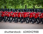 Soldiers in classic red coats march along The Mall in London, England in a grand Trooping the Colour spectacle of the Queen