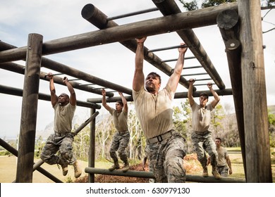 Soldiers climbing monkey bars in boot camp - Powered by Shutterstock