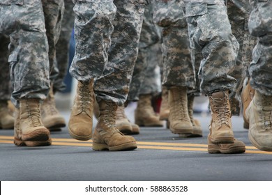 Soldiers dressed in army camouflage in an army parade  - Shutterstock ID 588863528