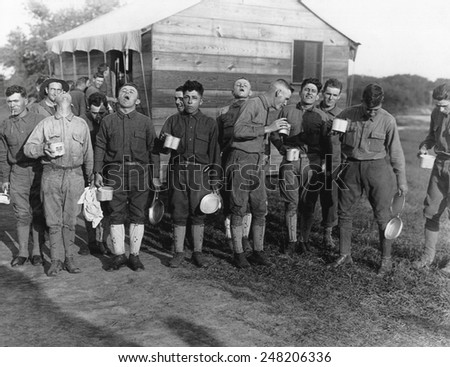 Soldiers gargle with salt and water to prevent influenza. Sept. 24, 1918. Camp Dix, New Jersey, during the 1918-19 'Spanish' Influenza pandemic.