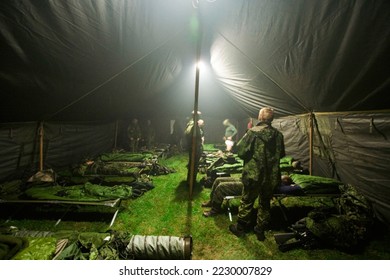 Soldiers getting ready to bunk down inside of their large tent - This is the real thing from KFOR, Kosovo 1999. This image is part of our historic collection. The digital cameras available back then - Powered by Shutterstock