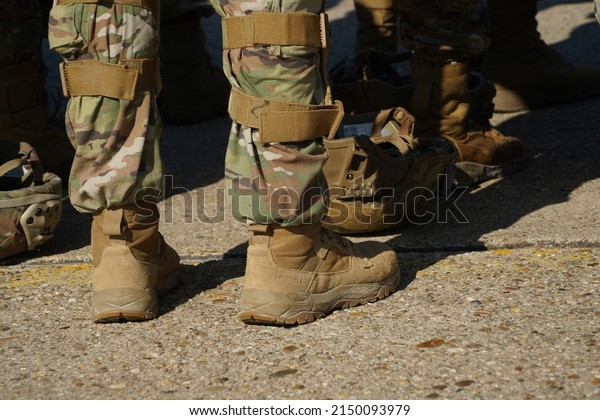 Soldiers parade boots feet and military\
equipment.Military uniform\
