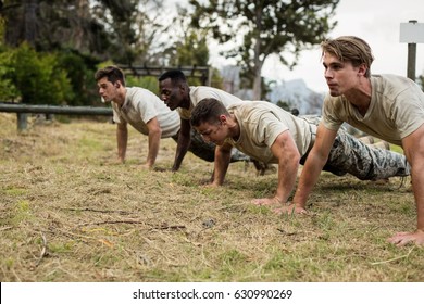 Soldiers performing pushup exercise in boot camp - Powered by Shutterstock