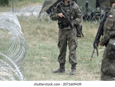 Soldiers of Poland on border. Polish soldiers near a fence on the border