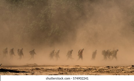 Soldiers Running Through A Sandstorm.