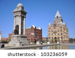 Soldiers and Sailors Monument and Syracuse Savings Bank Building at Clinton Square in downtown Syracuse, New York State NY, USA. Syracuse Savings Bank Building was built in 1876 with Gothic style.