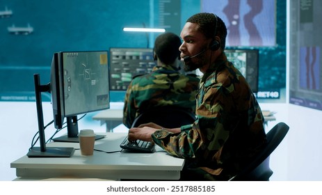 Soldiers in a state of the art military control room collaborate on data analysis, intelligence gathering, and mission planning. Ensure effectiveness and security of military operations. Camera A. - Powered by Shutterstock