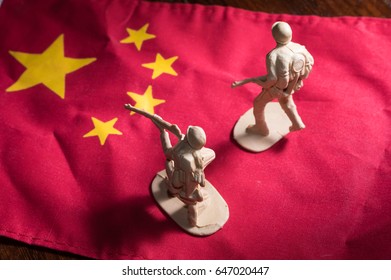 Soldiers toys on China national flag - Powered by Shutterstock