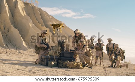 Soldiers are Using Drone And Laptop Computer for Scouting During Military Operation in the Desert.