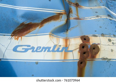 Soldotna, USA - JULY 15, 2016: American Motors Corporation (AMC) Gremlin Car Type Logo On A Blue And White Rusty Background