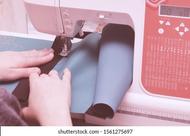 Sole Proprietor At Work At Home. A Seamstress Woman Is Engaged In Sewing According To Her Own Design.