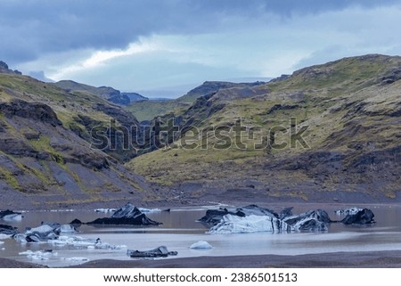 Solheimajokull picturesque glacier in southern Iceland. The tongue of this glacier slides from the volcano Katla. Beautiful glacial lake lagoon with blocks of ice
