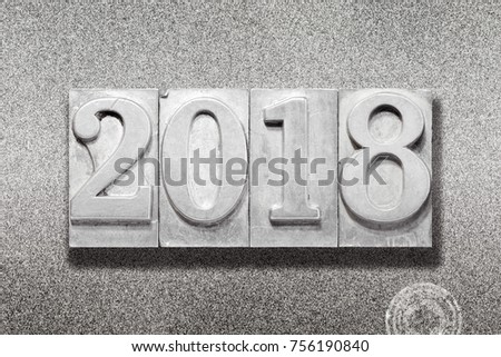solid 2018 numbers made from vintage letterpress on metallic textured background
