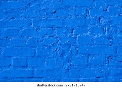 A solid blue painted brick wall surface with visible texture.