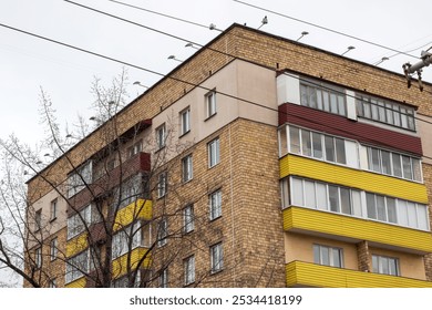 A solid brick building featuring a balcony located at the top of the structure, providing a charming view over the surroundings - Powered by Shutterstock