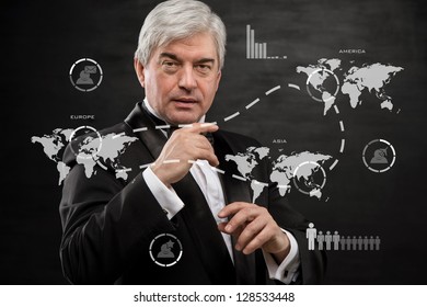 Solid business man working with virtual interface - building international business