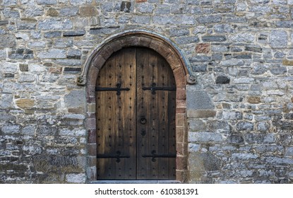 Solid castle wooden door arch door and stone wall