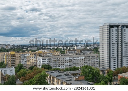 Solid cloud cover over the Dnipro city. View of the city from roof of high-rise buildings at before thunderstorm. Soviet structures are mixed with new modern residential buildings