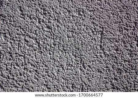 Solid concrete sturcture, white grained wall of the building