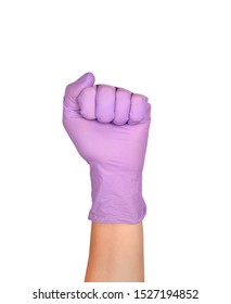 Solid Fist Or Anger Gesture In Latex Surgical Gloved Sign Against White Background. Hand In A Purple Latex Glove Isolated On White. Woman's Hand Gesture Or Sign Isolated On White.