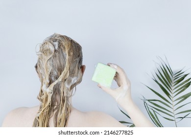 Solid hair shampoo. Close-up of a blonde girl in the bathroom, which lathers her hair with dry shampoo. Lots of foam and peek effect. - Shutterstock ID 2146277825