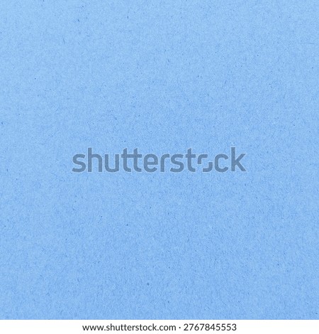 Solid light blue background with a soft, textured paper-like surface.