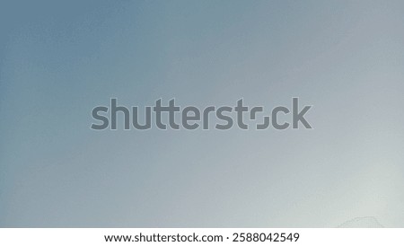 A solid, light blue sky fills the frame, suggesting a calm and peaceful atmosphere