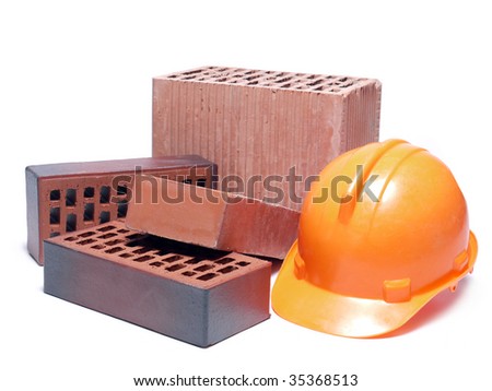 Solid and perforated bricks and orange hard hat isolated on white
