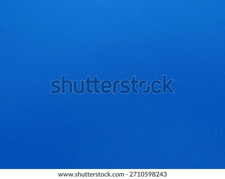 Solid, vibrant royal blue background with subtle, uniform surface texture.