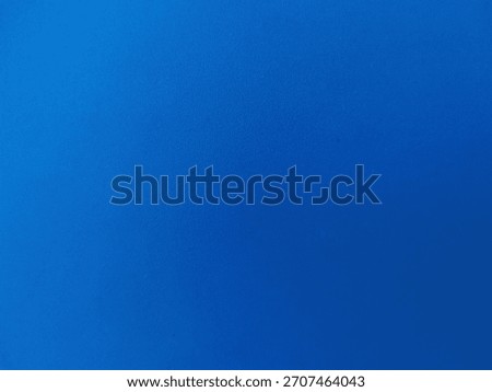 A solid, vibrant royal blue surface with a slight, fine-grained texture, suggesting a durable material like plastic or laminate.
