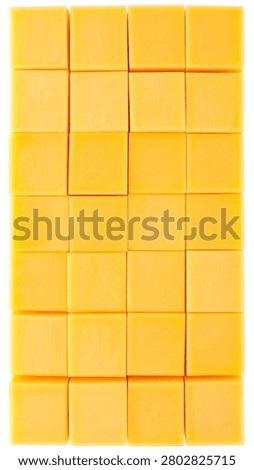 Solid yellow cheddar cheese cut into exact perfect geometric cubes arranged in a precise grid isolated on white.