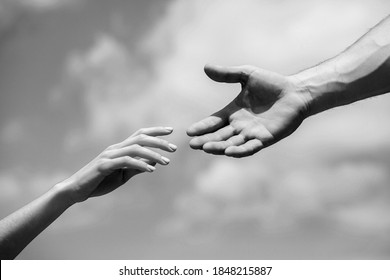 Solidarity, Compassion, And Charity, Rescue. Hands Of Man And Woman Reaching To Each Other, Support. Giving A Helping Hand. Lending A Helping Hand. Black And White.