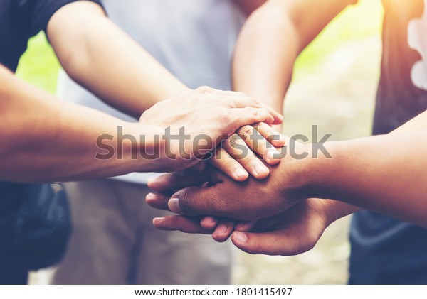 Solidarity unite people hands together community\
teamwork. Hands of spirit team working together outdoor. Unity\
strong handshake with people or agreement of feeling or happy\
diverse education\
action