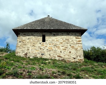 solidary stone hut on a hill - Shutterstock ID 2079358351