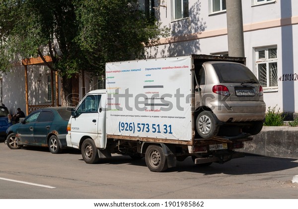 Sol-Iletsk, Russia, 08.27.2020. A small truck\
carries a small car. The Daewoo Matiz car is in the back of a\
Hyundai Porter\
truck.