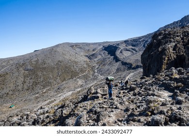 Solitary Trekker’s Ascent on Rugged Mountain Paths of Mt. Kilimanjaro - Powered by Shutterstock