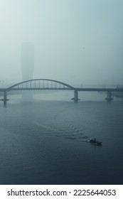 Solitary Boat On Sava River Under Branko's Bridge Covered In Morning Fog From Air Pollution, Belgrade Serbia, October 2022