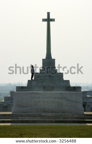 A solitary figure gazing up at a memorial to the First World War. Taken at Tyne Cot military cemetery, in Belgium.
