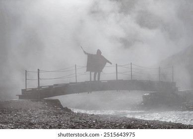 Solitary Figure on Misty Suspension Bridge Over Rocky Ravine - Powered by Shutterstock