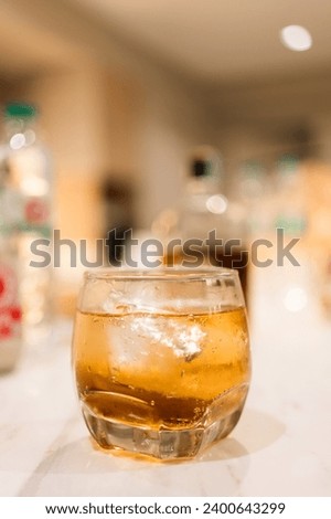A solitary glass of whiskey on the marble table